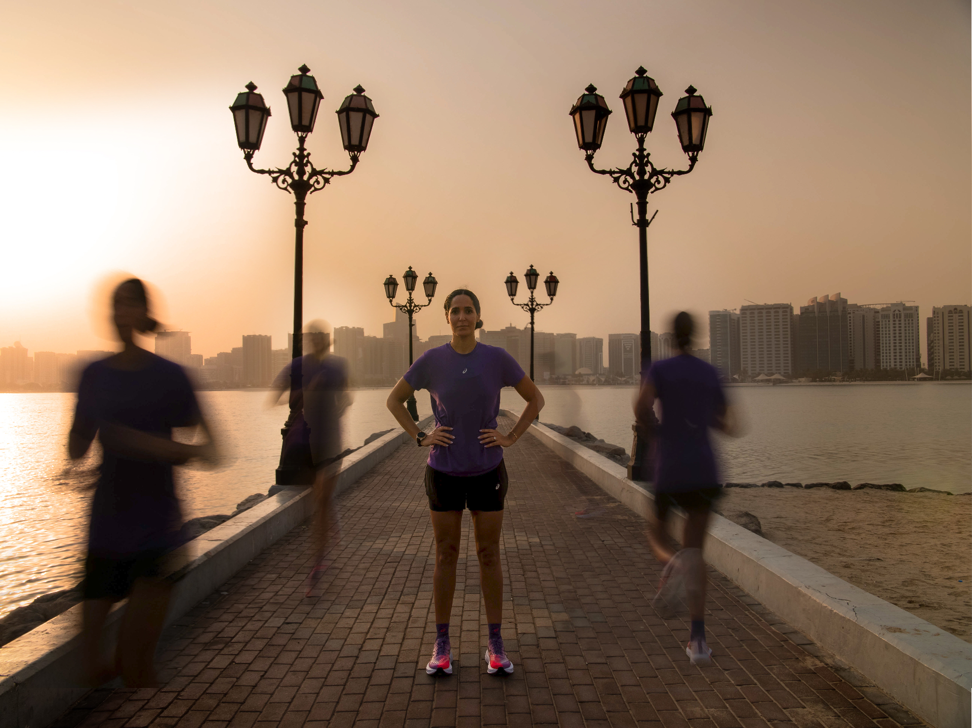 Dr Sarra Lajnef-Taylor in running kit at sunrise on the Abu Dhabi Corniche