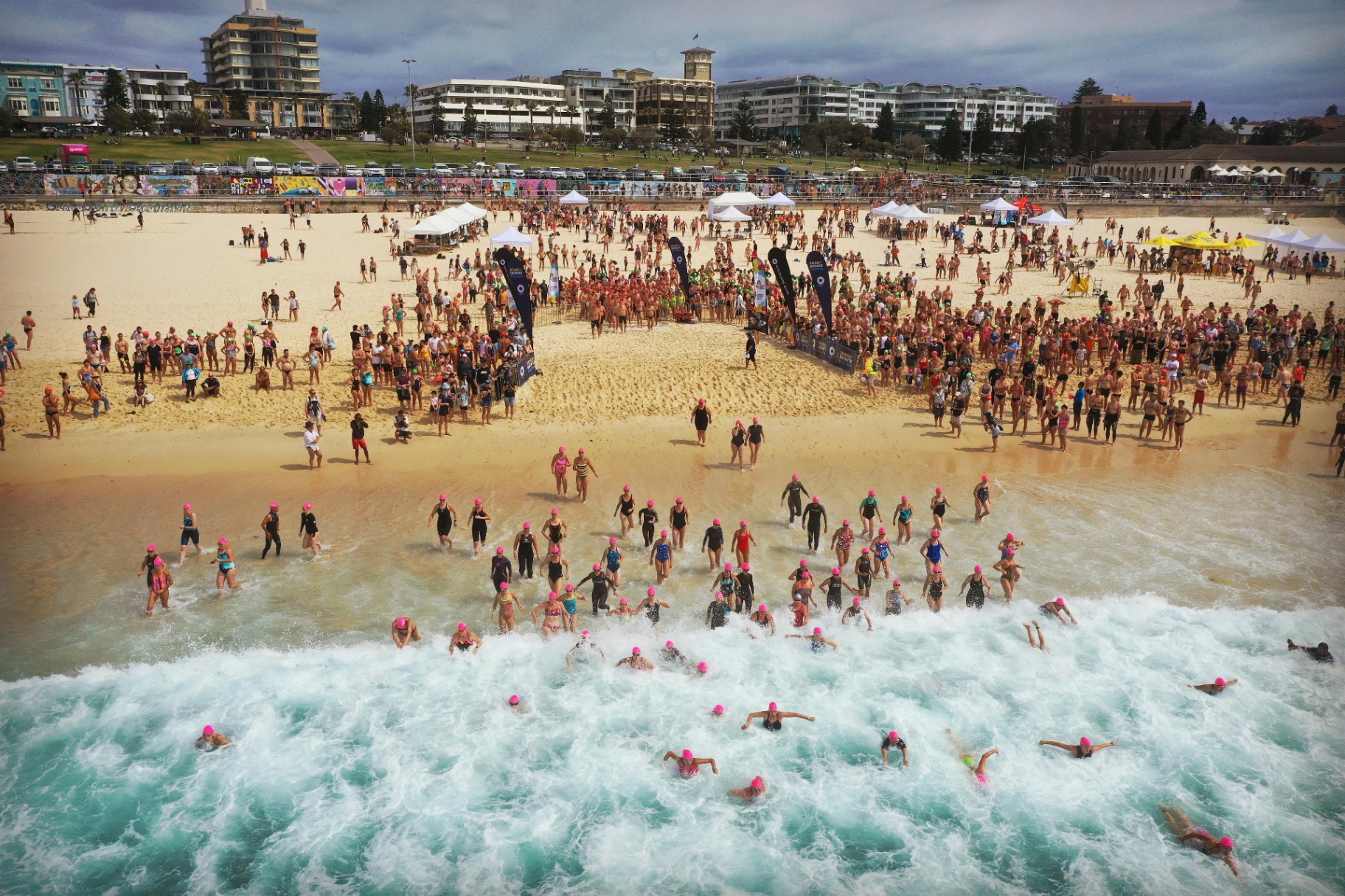 Large beach open-water swimming event starting from the shoreline