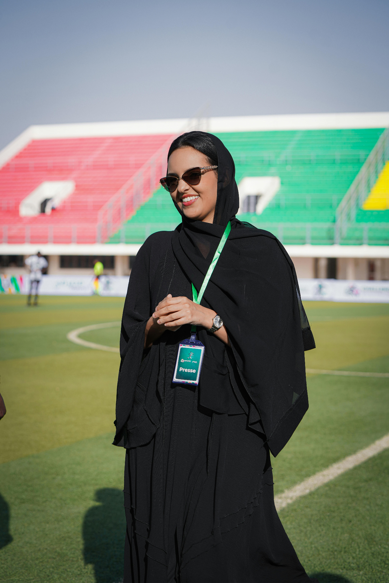 Female media representative on a UAE football pitch during a stadium press day